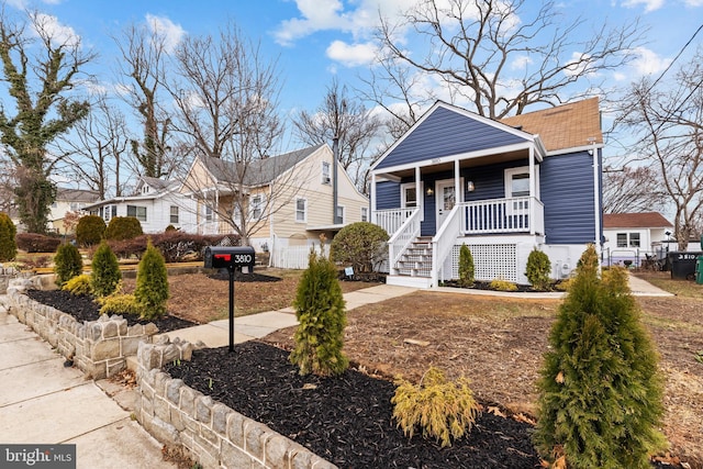 view of front of home featuring covered porch and fence