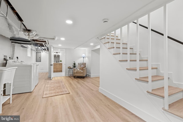 finished basement featuring stairs, light wood finished floors, recessed lighting, and washer and dryer