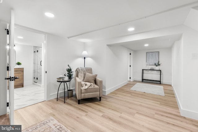 sitting room with baseboards, recessed lighting, and light wood-style floors