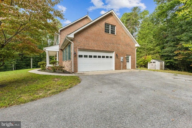 view of property exterior featuring a garage, a storage shed, aphalt driveway, a yard, and brick siding