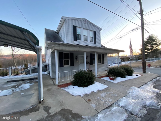 view of front of house with a porch and fence