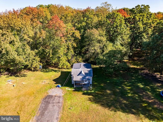 drone / aerial view featuring a wooded view