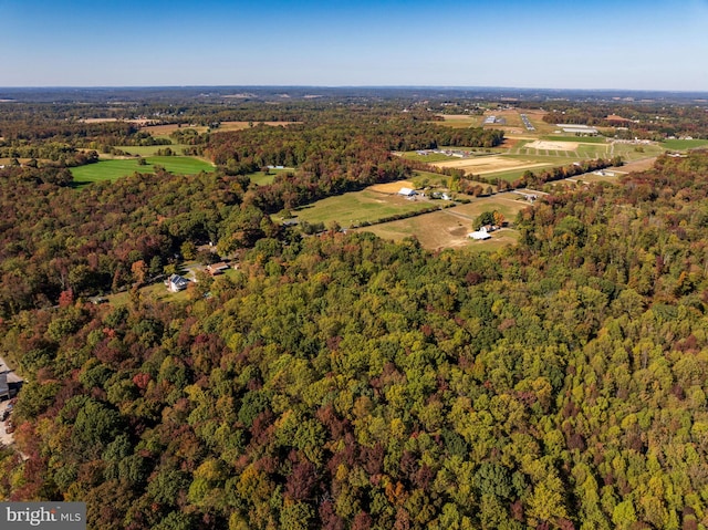 drone / aerial view featuring a forest view