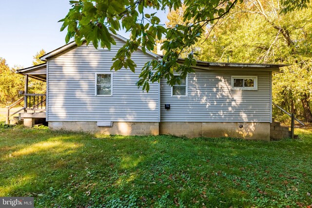 view of property exterior with a yard