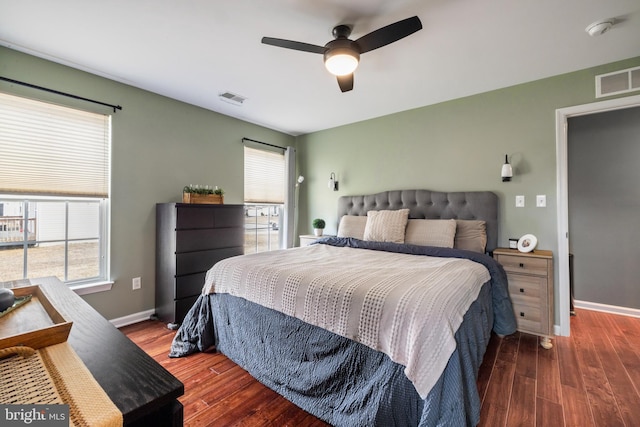 bedroom featuring dark wood finished floors, visible vents, and baseboards