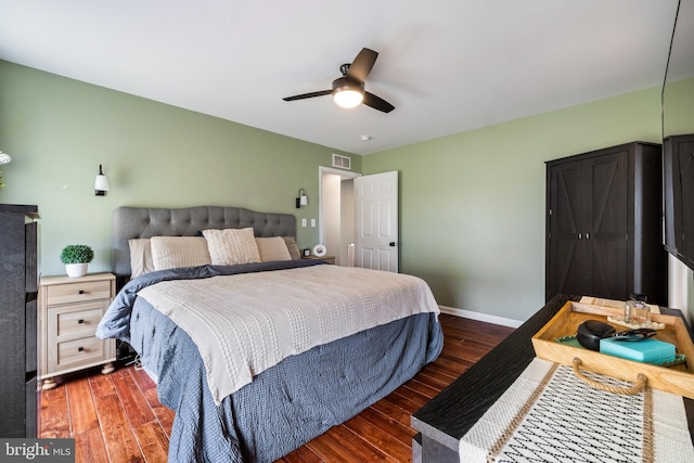 bedroom with dark wood-style floors, baseboards, visible vents, and a ceiling fan