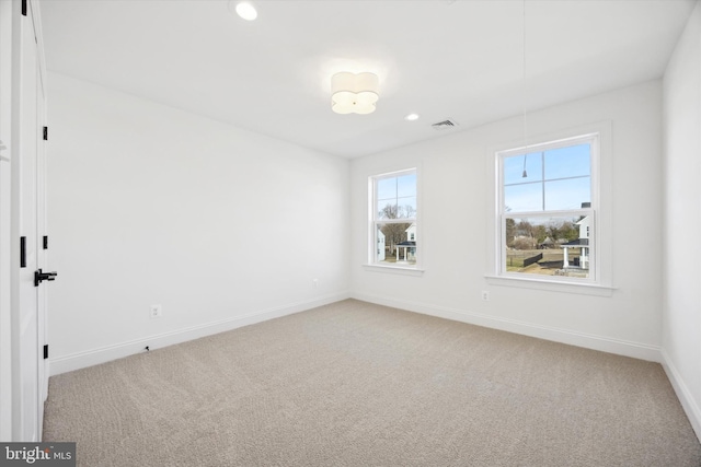 empty room featuring recessed lighting, visible vents, carpet flooring, baseboards, and attic access