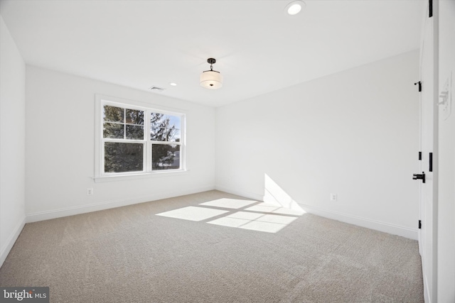 unfurnished room featuring baseboards, light carpet, recessed lighting, and visible vents