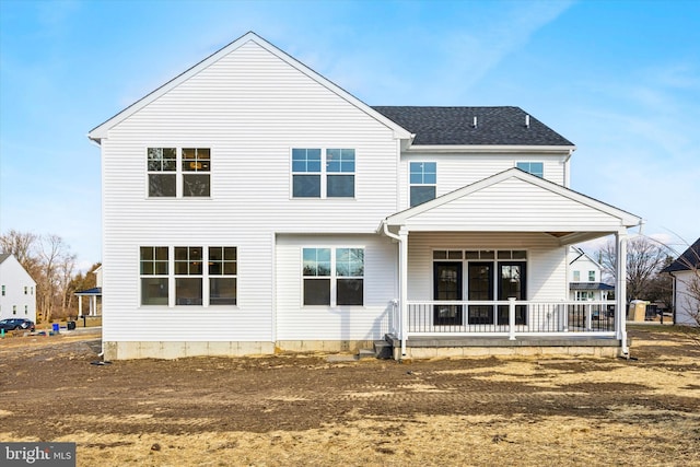 back of property featuring roof with shingles and covered porch