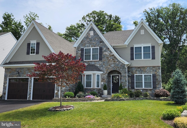 view of front of property featuring driveway, a front lawn, an attached garage, and stucco siding