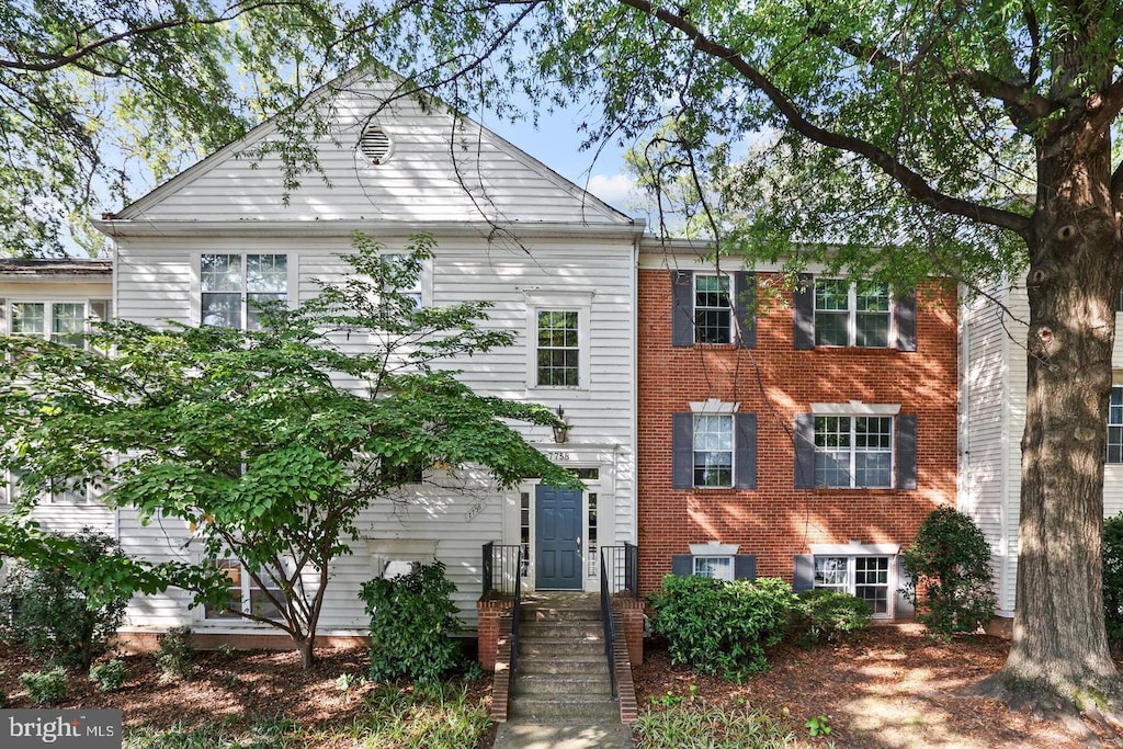 view of front of house featuring brick siding