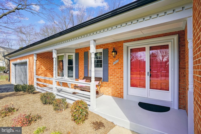 doorway to property with brick siding and a porch