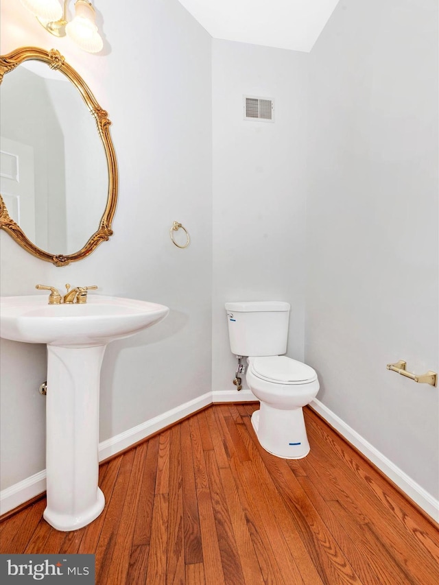 bathroom featuring toilet and hardwood / wood-style flooring