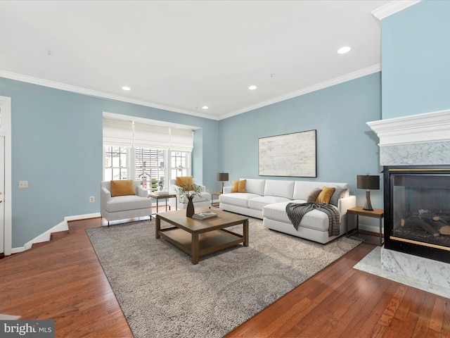 living room featuring a fireplace, ornamental molding, and wood-type flooring