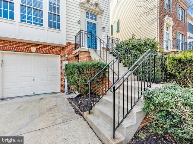 doorway to property with a garage