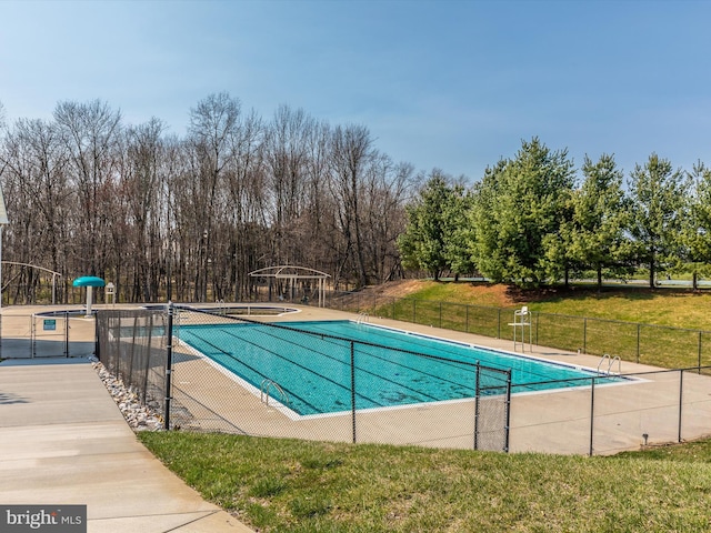 view of swimming pool featuring a yard