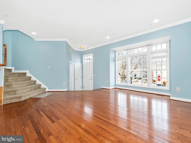 unfurnished living room featuring hardwood / wood-style flooring and ornamental molding