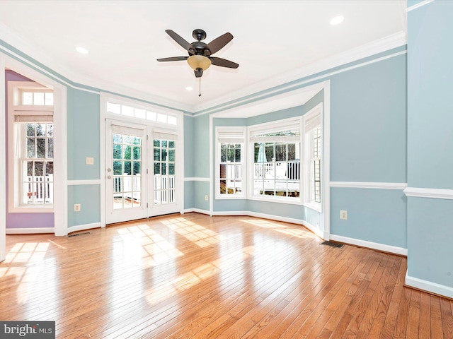 unfurnished room featuring ceiling fan, ornamental molding, and light wood-type flooring