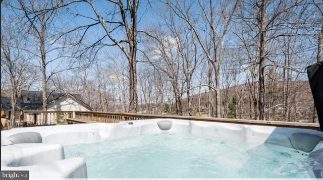 snow covered pool with a hot tub