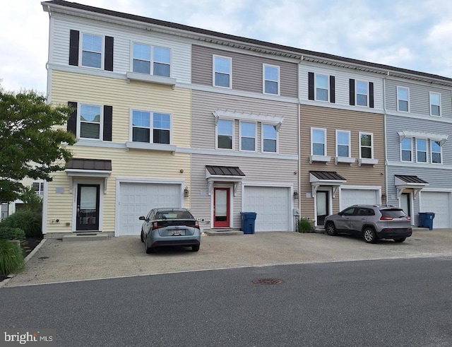 townhome / multi-family property featuring a garage and driveway