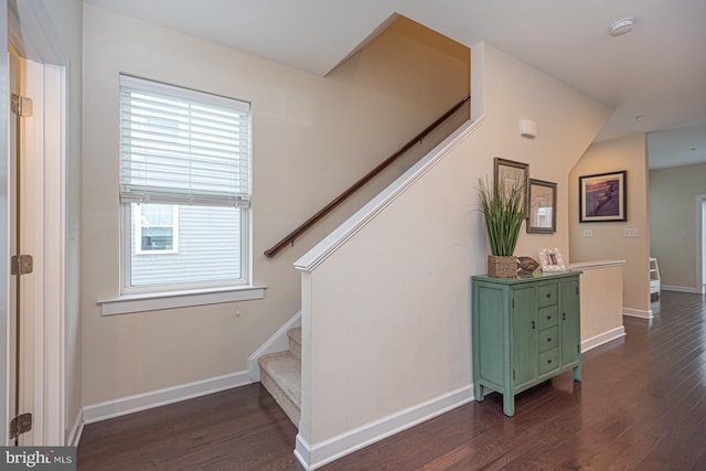 stairway featuring wood finished floors and baseboards