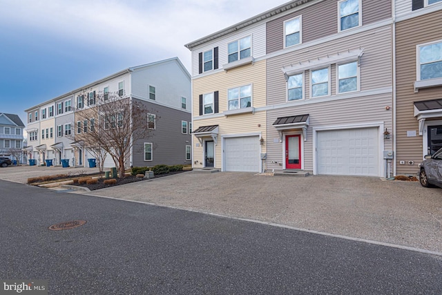 multi unit property featuring driveway and an attached garage