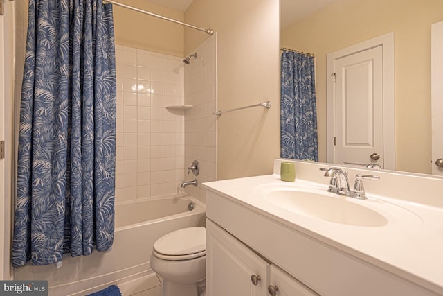 bathroom featuring shower / bath combo, vanity, and toilet