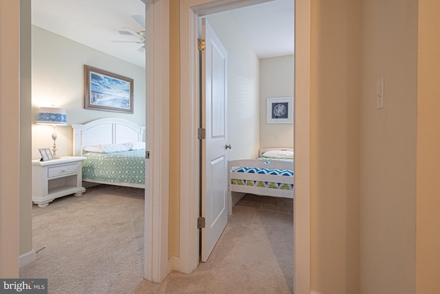 hallway with light carpet and baseboards