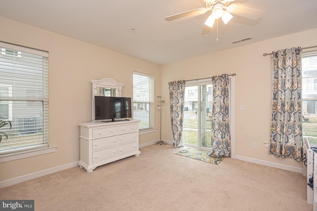 bedroom with light colored carpet, access to outside, visible vents, and baseboards