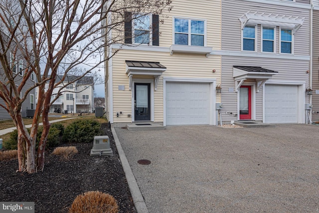 multi unit property featuring an attached garage