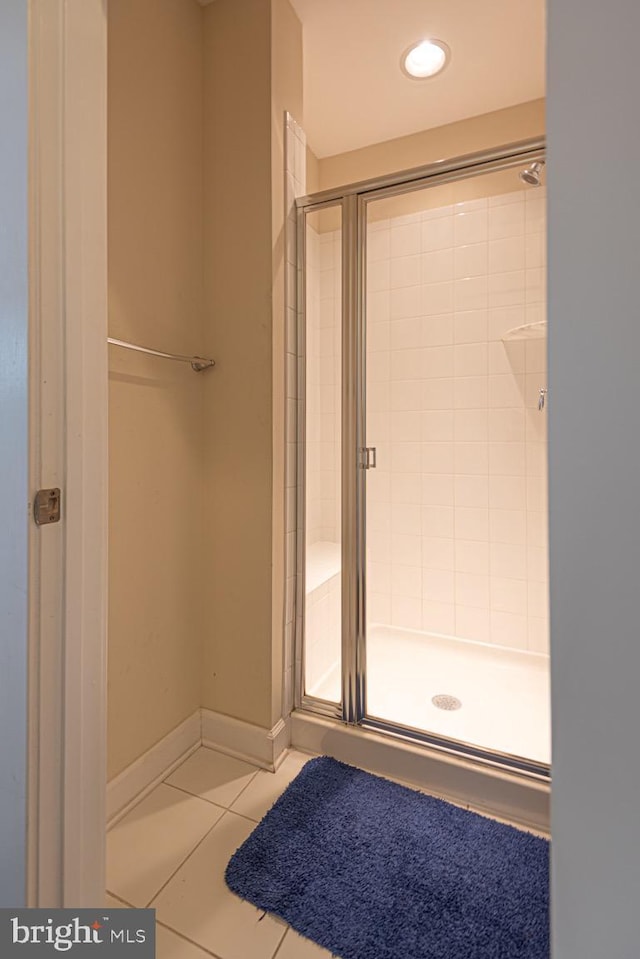 full bath featuring a stall shower, recessed lighting, baseboards, and tile patterned floors