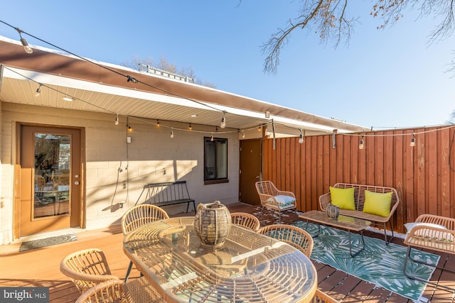 exterior space with fence and outdoor dining area