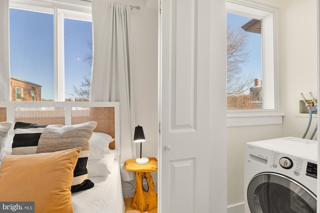 washroom featuring a wealth of natural light, washer / dryer, and laundry area