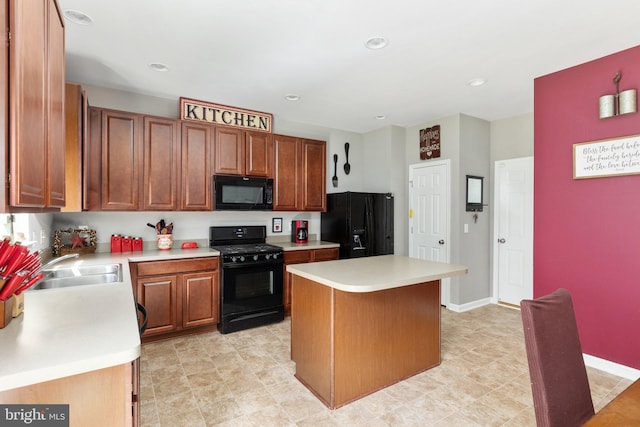 kitchen featuring brown cabinetry, a kitchen island, light countertops, black appliances, and a sink