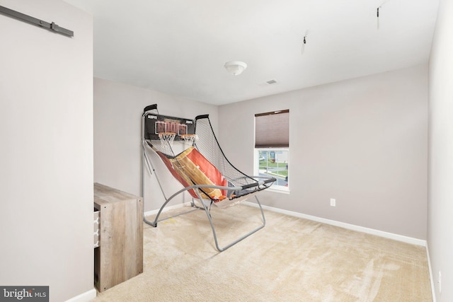 interior space featuring light carpet, visible vents, and baseboards