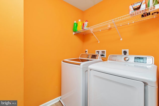 clothes washing area featuring laundry area, independent washer and dryer, and baseboards