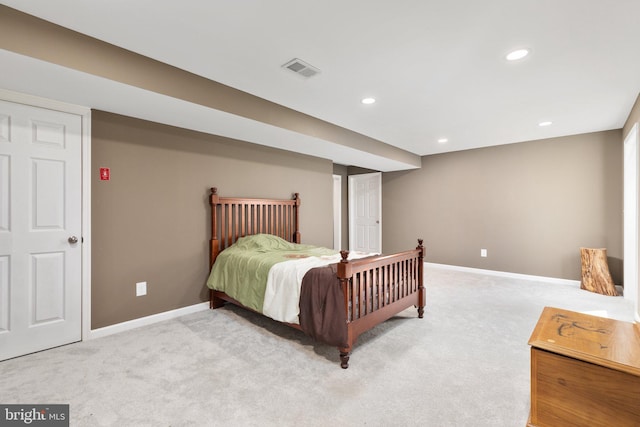 bedroom with recessed lighting, light carpet, and baseboards