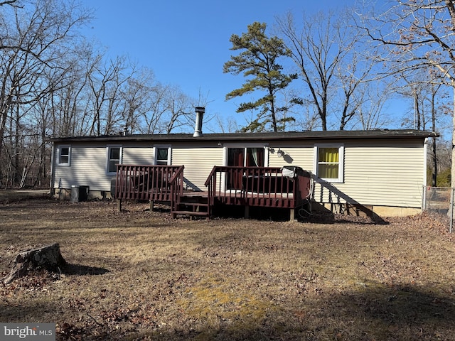 rear view of house with a deck and central AC unit