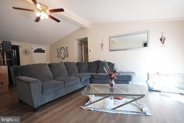 living area with vaulted ceiling with beams, ceiling fan, dark wood-type flooring, and a textured ceiling