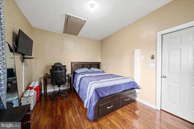 bedroom featuring baseboards and wood finished floors