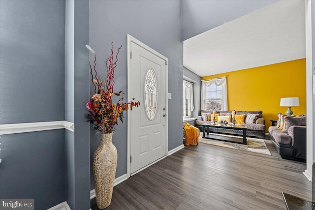 foyer with baseboards and wood finished floors