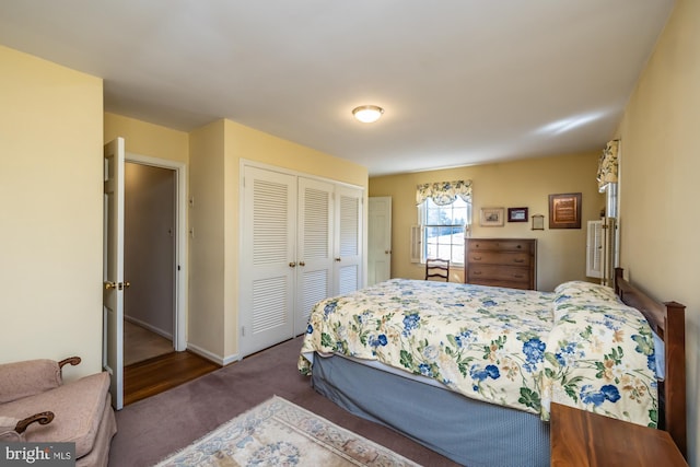 bedroom with a closet, carpet flooring, and baseboards