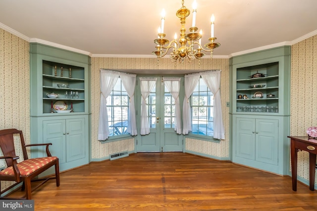 interior space featuring dark wood-style floors, ornamental molding, visible vents, and wallpapered walls