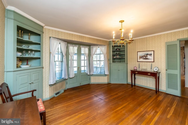 unfurnished dining area with dark wood-style floors, crown molding, and wallpapered walls