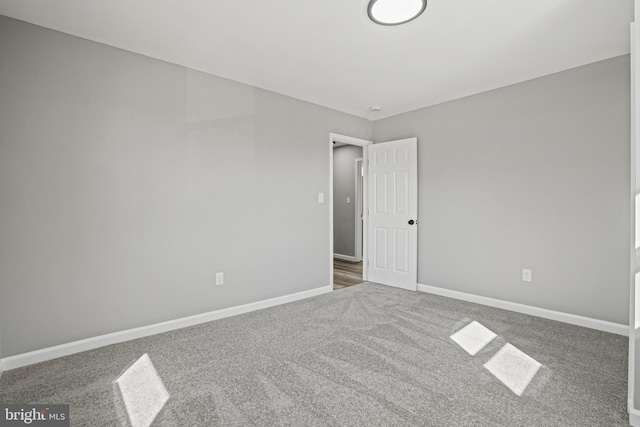 empty room with carpet flooring and baseboards