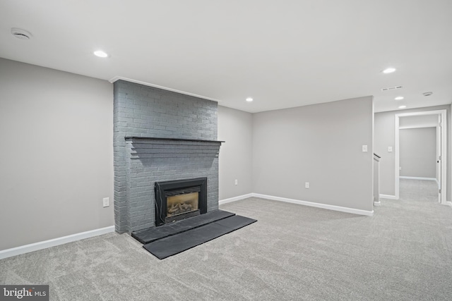 unfurnished living room featuring light carpet, recessed lighting, a fireplace, and baseboards