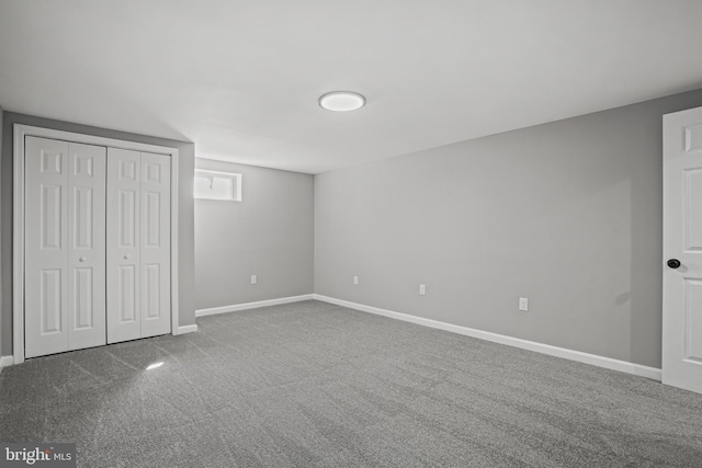 unfurnished bedroom with a closet, carpet flooring, and baseboards