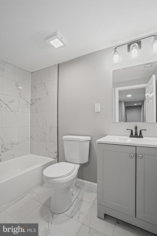 bathroom featuring toilet, marble finish floor, vanity, and bathing tub / shower combination