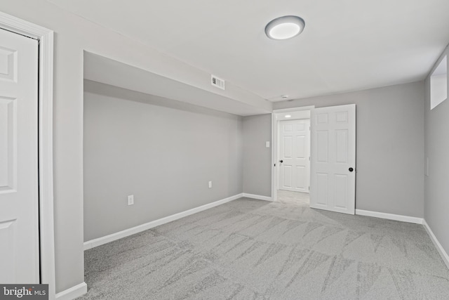 unfurnished bedroom featuring light colored carpet, visible vents, and baseboards