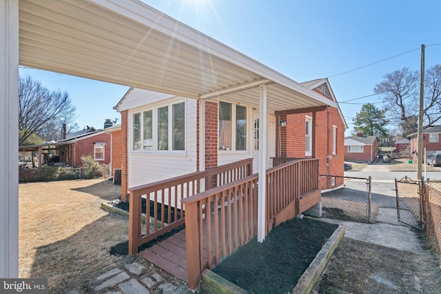 exterior space with brick siding and cooling unit